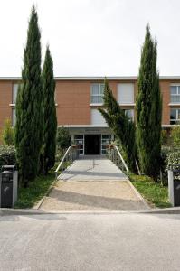 a building with trees in front of it at Residhotel Les Hauts d'Andilly in Andilly