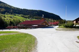 a large building with a church in front of a mountain at Actif 305 Apartment by Ål Ski Center in Al