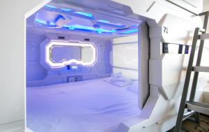 a small room with a bed in an airplane at Capsule Hostel Capslock in Kazan