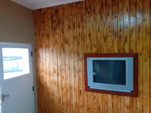 a television on a wooden wall in a room at Hospedar in Puerto Rico