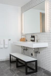 a bathroom with a sink, toilet, and cabinet at Hotel Saint George in Marfa