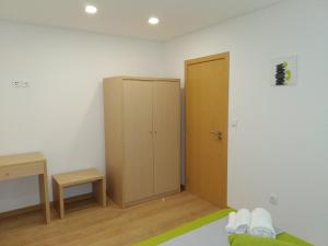 a bedroom with a closet and a cabinet in it at Casa Do Boteco in Santa Marta de Penaguião