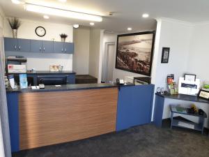 an office with a reception counter with blue cabinets at Bay Viaduct Motor Lodge in Timaru