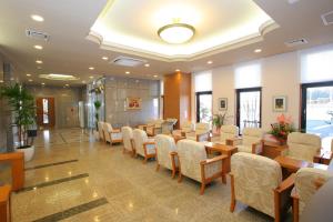 a conference room with chairs and tables in a building at Hotel Route-inn Koriyama Inter in Koriyama +23 photos