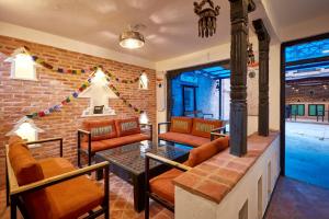 a room with chairs and a brick wall at Mangal Chhen in Pātan