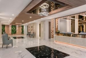 a lobby of a hotel with a reception desk at Adelphi Grande Sukhumvit in Bangkok