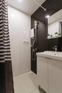 a white bathroom with a shower and a sink at U3 Large 2 Bedroom Full kitchen near BTS Udomsuk in Bangkok +31 photos