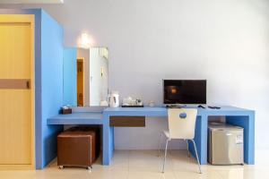 a blue desk with a computer and a chair at Sea Suite Villa in Bang Rak Beach