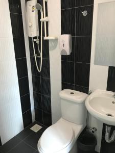 a bathroom with a toilet and a sink at GOODY HOTEL in Johor Bahru +18 photos