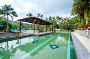 a swimming pool in a resort with a gazebo at Butchard Villas in Yuchi