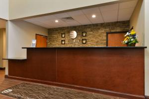 a reception desk in a hospital lobby with flowers at Comfort Inn and Suites Manheim in Manheim