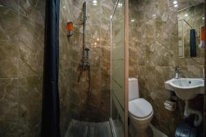 a bathroom with a shower and a toilet and a sink at 1STHOSTEL in Achinsk