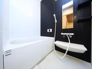 a bathroom with a white sink and a mirror at COTO Tokyo Asakusa 5 in Tokyo +19 photos