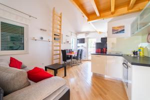 a living room with a couch and a kitchen at Cro Behar 2 Apartments in Sveti Petar