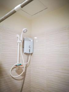 a bathroom with a white shower in a room at Bamboo Bay Condominium near UC Med & Chong Hua Hospital, CDU School, SM Mall, Ayala Mall and IT Park - studio condo unit in Cebu City