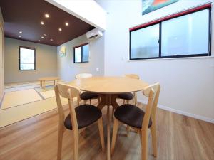 a dining room with a wooden table and chairs at COTO Tokyo Asakusa 5 in Tokyo