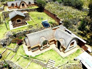 an aerial view of a house with a roof at Ecolodge Copacabana in Copacabana