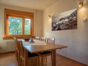a dining room with a wooden table and chairs at Alpeambient house Dovje in Mojstrana