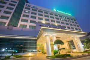 a hotel front of a building at night at Emerald Garden International Hotel in Medan