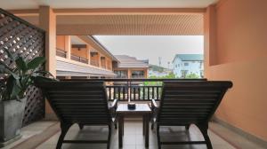 two chairs and a table on a balcony at La Maison Hua Hin in Hua Hin