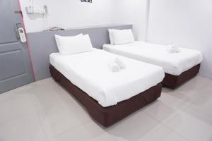 Postel nebo postele na pokoji v ubytování Ma Non Nont Hotel & Apartment
