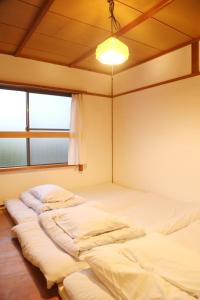 Postel nebo postele na pokoji v ubytování Y Pub & Hostel Tottori