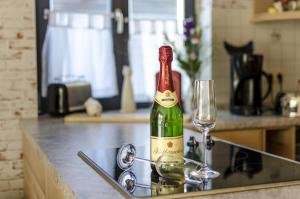 a bottle of wine sitting on a counter with a glass at Stadthaus Waren in Waren