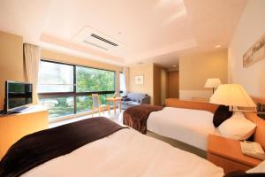 Postel nebo postele na pokoji v ubytování Hotel Shikisai