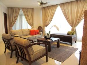 een woonkamer met een bank en een tafel bij Samsuria Beach Resort & Residence in Cherating