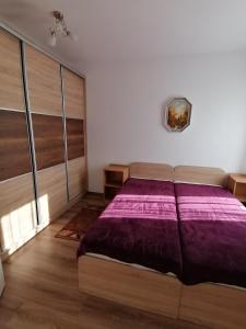 A bed or beds in a room at Ádám Guesthouse I.