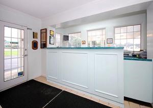 a kitchen with white cabinets and a blue counter top at Ambassador Inn in Fayetteville