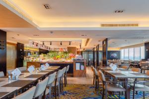 a restaurant with tables and chairs and a bar at Zhejiang Hotel in Hangzhou