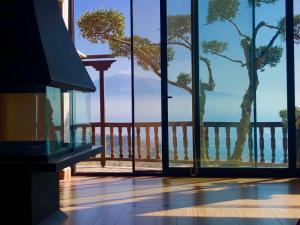 a room with a view of the ocean through glass at Balcone sull'Etna Casa Biondi in Centuripe