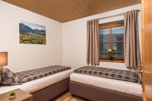 a room with two beds and a window at Ferienhaus "Kaprun" in Kaprun