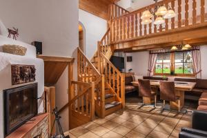 a living room with a staircase and a dining room at Ferienhaus "Kaprun" in Kaprun