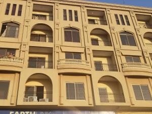 a large building with balconies and people on the balcony at Rove Lodging-One Bed Apartment,Bahria Town in Rawalpindi