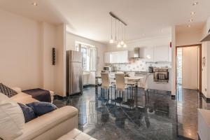 a kitchen and living room with a table and chairs at Locanda Bella Fra in Blevio