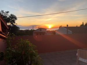 a sunset seen from a roof of a house at Pandora's Corfu Apartments in Agios Gordios
