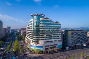a tall building in the middle of a city at Zhejiang Hotel in Hangzhou