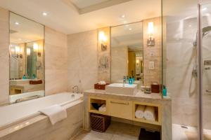 a bathroom with a tub and a sink and a shower at Zhejiang Hotel in Hangzhou +43 photos