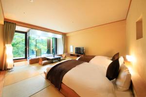 Postel nebo postele na pokoji v ubytování Hotel Shikisai