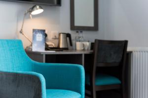 a room with two chairs and a desk with a lamp at Belmont Llandudno in Llandudno