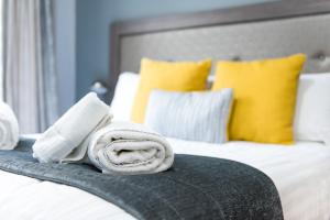 a bed with two towels on top of it at Belmont Llandudno in Llandudno