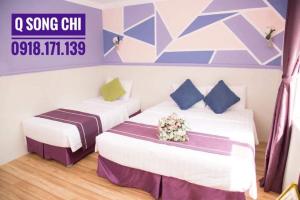 Postel nebo postele na pokoji v ubytování Q Songchi Hotel
