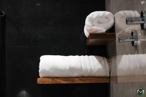 a bathroom with two towels on a shelf at MARGHERITA BOUTIQUE ROOMS in Margherita di Savoia +53 photos