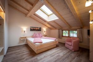 a bedroom with a large bed and a skylight at Beim Neuner - Zeit zu zweit in Oberaudorf