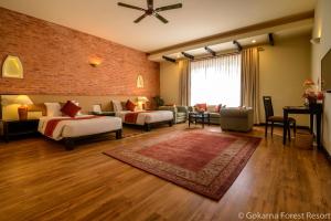 
a living room with a large bed and a large window at Gokarna Forest Resort in Kathmandu
