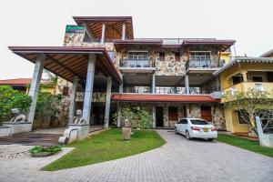 a car parked in front of a building at Jasmin Villa Ayurveda Resort in Negombo