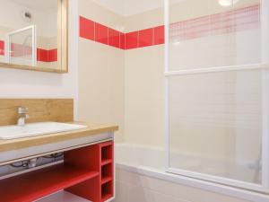 a bathroom with a sink and a shower at travelski home select - Résidence Les Lys in Les Menuires