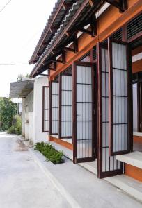 a building with large windows on the side of it at Tama House in Tây Ninh